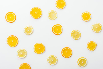 Top view of juicy cut fruits on white surface