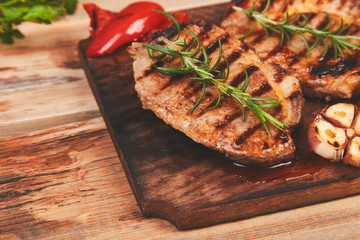 Steak pork grill on wooden cutting board