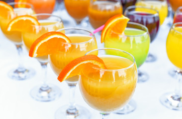 Many glasses with juice on table 