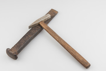 Cold chisel and hammer on white