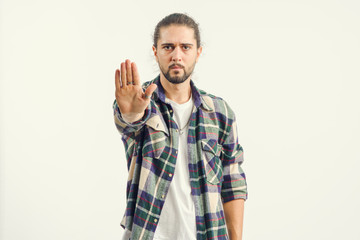 Stop. Portrait of a young man shows hands a gesture of denial, refusal. No, ban - concept.