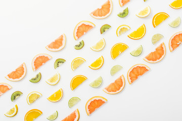 Flat lay with juicy cut fruits on white surface