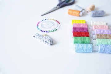 scissors and thread, needles, meter, on white background with copy space for text
