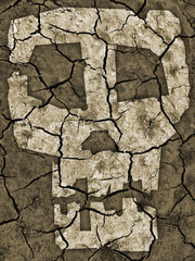 Distressed dry cracked earth with symbol of skull.  Photo-montage with Dry cracked earth and  stylized human skull. Symbol of catastrophic drought and global warming. 