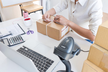 Young entrepreneur SME receive order client and working with packaging sort box delivery online market on purchase order and preparing package product, Small business parcel for shipment