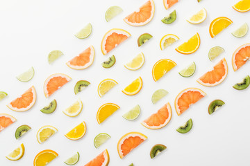 Flat lay with juicy cut fruits on white surface