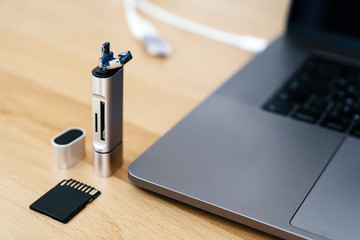Digital Type-C USB Memory Card Reader, with gray laptop with USB Type-C port. Macro