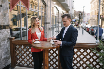 Young couple of professionals chatting during a coffee break