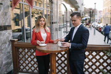 Young couple of professionals chatting during a coffee break