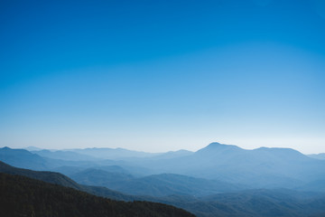 Fototapeta na wymiar Beautiful blue landscape with white fog mountains.