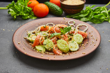 Fresh spring detox mix salad with vegetables such as tomatoes, cucumbers and onion
