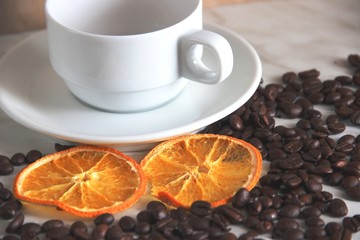 classic cup and saucer, coffee beans and dried orange mugs. concept love of coffee and citrus