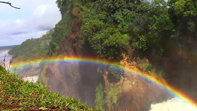 The origins of the Nile River in Africa in Uganda flows through sheer rapids and forms raging waterfalls. Splashes are turned into droplets and form a colorful beautiful rainbow