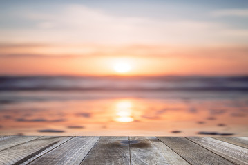 Empty wooden table and beautiful ocean with sunset.