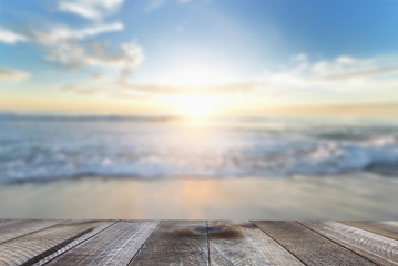Naklejka na ściany i meble Empty wooden table with blue sea and sand beach background.
