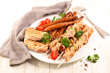 assorted barbecue meat with sausage, pork chop and beef skewer