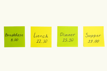 Multicolored stickers with notes. Breakfast, lunch, dinner, supper.