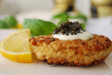 black caviar served on a dish with sour cream 