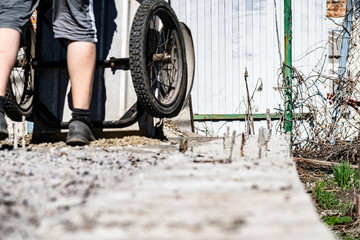 Naklejka premium Simple small gravel, stones in grey in old aluminum car wheels. To transport the material and to pour into the building.