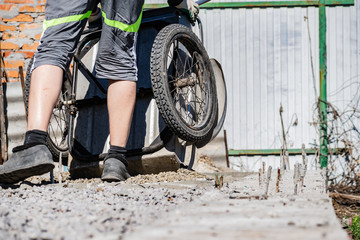 Simple small gravel, stones in grey in old aluminum car wheels. To transport the material and to...