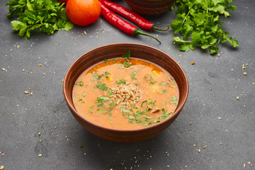 Traditional Georgian soup Kharcho with meat and rice on dark stone background