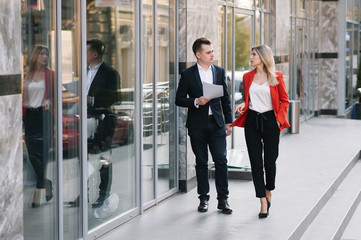 Business people walking and talking in the street ear of modern building.