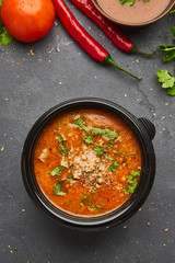 Traditional Georgian soup Kharcho with meat and rice on dark stone background