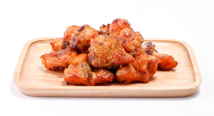 Chicken butt grilled on wooden plate isolated on white background, traditional street food in thailand
