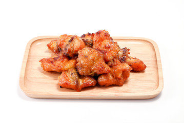 Chicken butt grilled on wooden plate isolated on white background, traditional street food in thailand