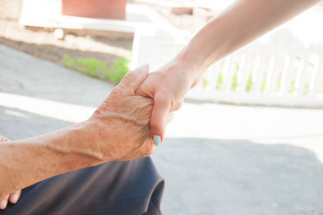 handshake of an old man with a girl on an isolated white background