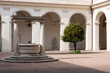 Fototapeta premium A building courtyard with an old well