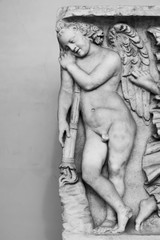 Fototapeta na wymiar Nude angel carved in stone