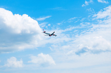 Commercial airplane landing at the airport with cloudy sky in the background