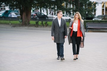 Young business people walking together along the street