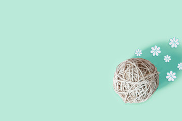 decorative ball of yarn on a blue background and blue flowers