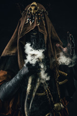 Portrait of a shaman holding a steaming horn