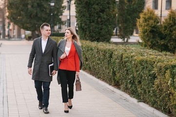 Business people walking and talking in the street