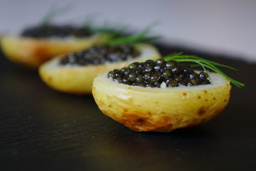 black caviar served on potato 