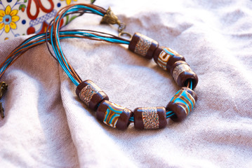 Handmade beaded tube necklace. Polymer clay jewellery. Still life boho style.