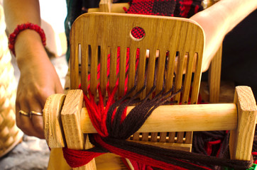 Weaving loom with fibers red and brown