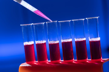 Test tube in rack and pipette media dispenser.