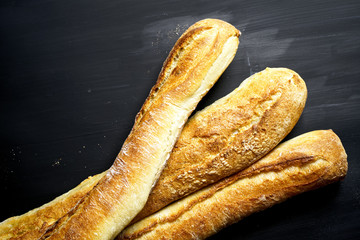 Three baguette on black background