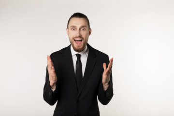 Elegant businessman over isolated white background clueless and confused expression hands raised