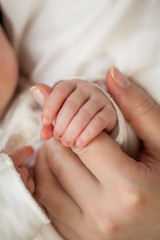 Close-up. Handles little baby in my mother's hands. Motherhood.