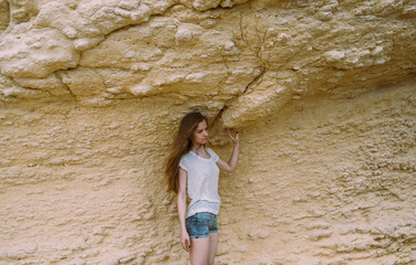 Portrait of young girl  posing near mountain wall