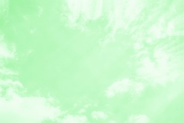 Soft delicate mint color sky background with white clouds.Copy space, toned photo