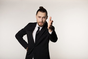 Business and office concept, handsome attractive businessman in black suit and tie with trendy hairstyle and beared