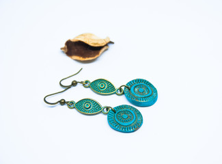 Boho chic earrings turquoise and bronze. White background with jewelry. Fashion handmade  jewellery.