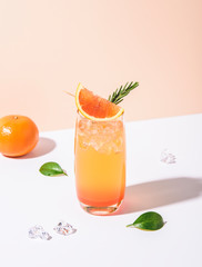 Cold and refreshing orange punch cocktail with orange slice on color background. summer drink.