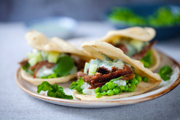 Mini flat breads with crispy lamb, mashed peas, cucumber, mint and yogurt sauce